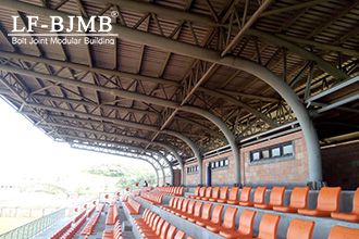 Why are tube trusses so widely used in large-space buildings?